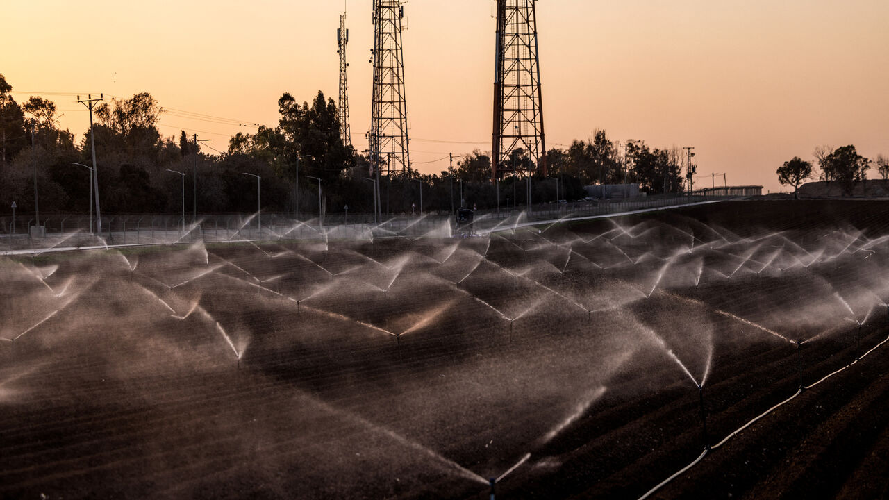 Sprinklers water fields in Kibbutz Nahal Oz in southern Israel, October 30, 2025. Hamas gunmen killed 15 people from Nahal Oz and took eight more hostage to Gaza on October 7, 2023. REUTERS/Ronen Zvulun