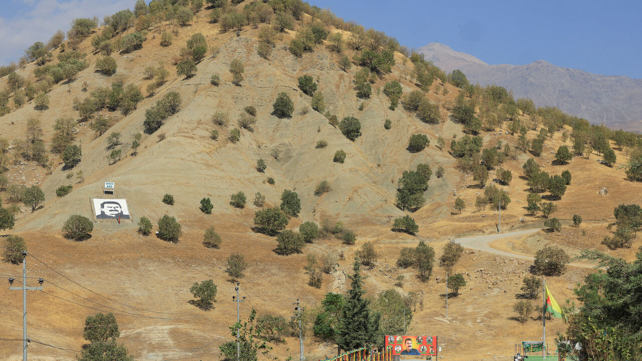 A portrait of jailed Kurdistan Workers Party (PKK) leader Abdullah Ocalan and a sign with the words "Serok Apo," are displayed on a hillside in the Qandil mountains, Iraq, October 26, 2025. REUTERS/Thaier Al-Sudani