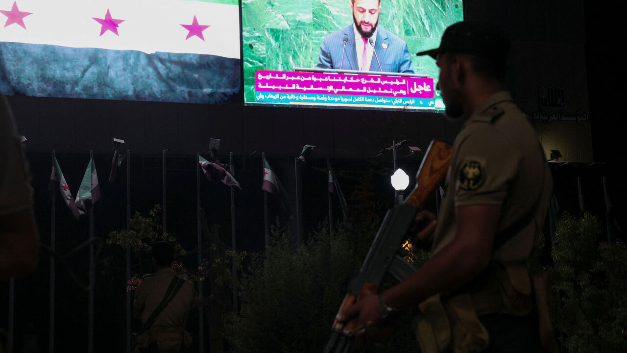 A member of the Syrian security forces stands during President Ahmad al-Sharaa's address at the United Nations General Assembly meeting, in Aleppo, Syria, Septemper 24, 2025. REUTERS/Mahmoud Hassano