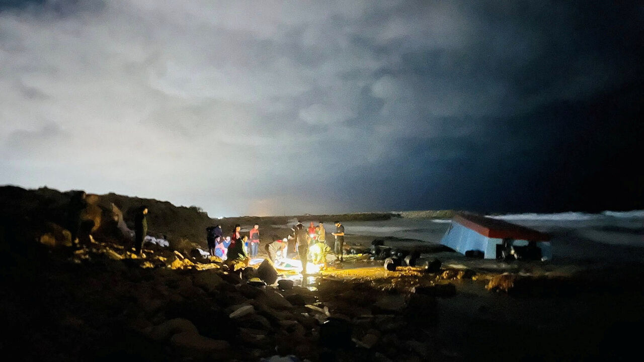 People hold a body bag in a location given as near Surman, Libya, after a migrant boat capsized west of Libya's capital Tripoli, in this handout image released on October 28, 2025. Libyan Red Crescent Society in Sabratha/Handout via REUTERS/File Photo
