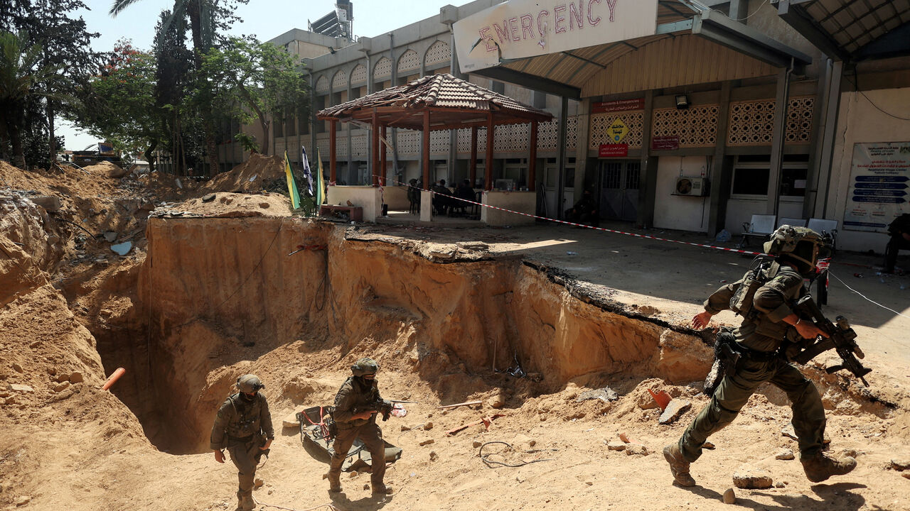FILE PHOTO: Israeli soldiers walk out from a tunnel underneath the European Hospital in Khan Younis at the Gaza Strip, amid the ongoing ground operation of the Israeli army against Palestinian Islamist group Hamas, June 8, 2025. REUTERS/Ronen Zvulun/File Photo