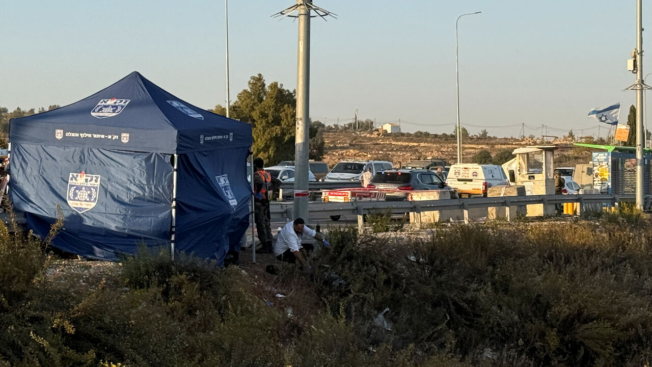 A member of ZAKA Search and Rescue examines the remains of a body at the scene of what Israel's ambulance services said was a fatal stabbing attack at the Gush Etzion junction in the Israeli-occupied West Bank November 18, 2025. REUTERS/Dedi Hayun