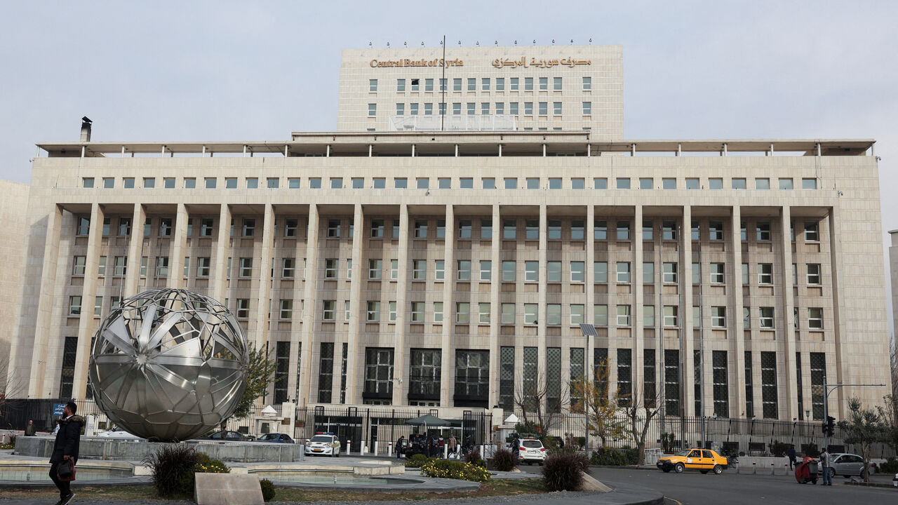 People and cars are seen in front of the Central Bank of Syria in Damascus, Syria December 11, 2024. REUTERS/Amr Abdallah Dalsh