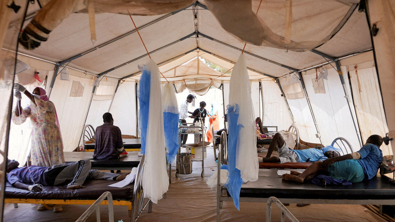 FILE PHOTO: Injured displaced Sudanese people who fled violence in al-Fashir receive treatment at a makeshift clinic run by Medecins Sans Frontieres (MSF), amid ongoing clashes between the paramilitary Rapid Support Forces (RSF) and the Sudanese army, in Tawila, North Darfur, Sudan November 3, 2025. REUTERS/Mohamed Jamal/File Photo
