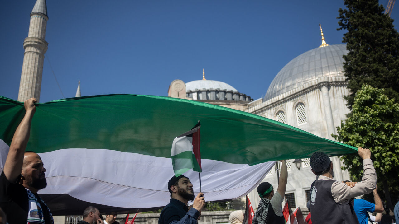 ISTANBUL, TURKEY - JUNE 01: People carry a large Palestinian flag during a protest to express support for Palestinians in Gaza outside the Hagia Sophia Grand Mosque on June 01, 2025 in Istanbul, Turkey. Protests continue as talks between Hamas, Israel and the U.S continue to seek a ceasefire deal and negotiate for a permanent end to the war. (Photo by Chris McGrath/Getty Images)