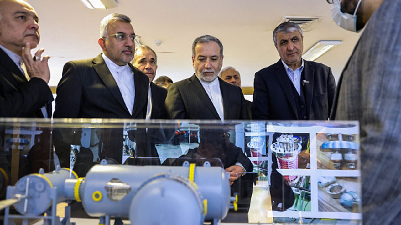 In this handout photo released by the Atomic Energy Organization of Iran (AEOI) on November 10, 2025, Iran's Foreign Minister Abbas Araqchi (L) is accompanied by AEOI chief Mohammad Eslami during a visit to a facility in Tehran. (Photo by Atomic Energy Organization of Iran / AFP)