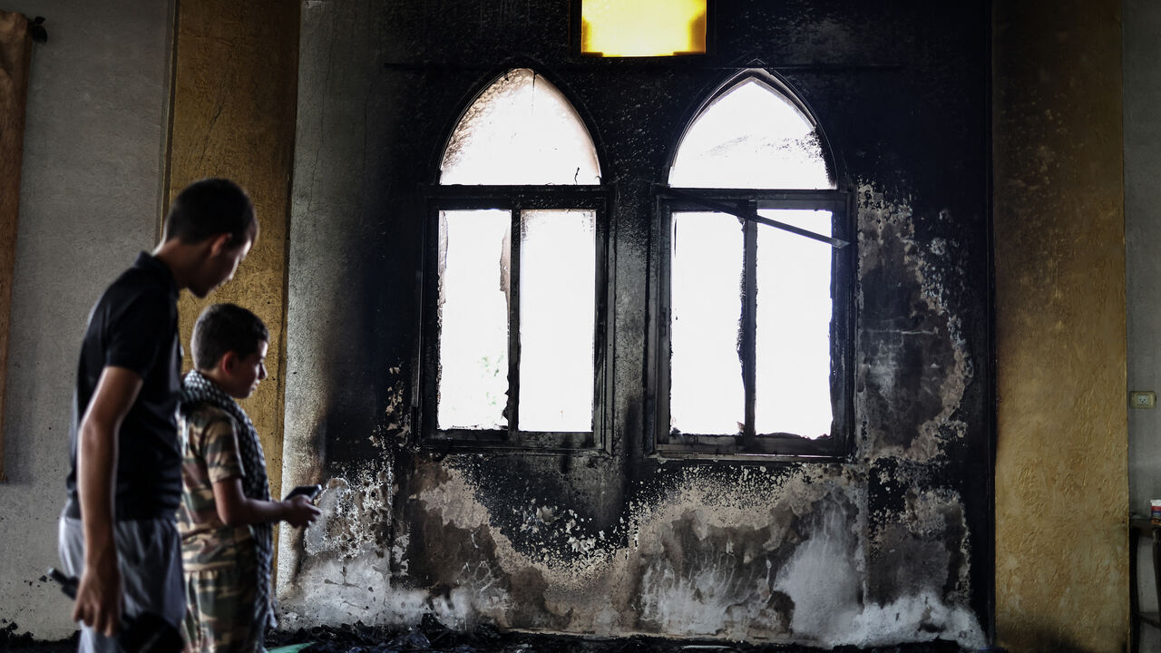 Young Palestinians look at the damage in the Hajja Hamida Mosque after it was reportedly set on fire and vandalised by Israeli settlers in the Palestinian village of Deir Istiya, near Salfit in the Israeli-occupied West Bank, on November 13, 2025. Violence in the West Bank has soared since the war in Gaza broke out in October 2023. (Photo by Zain JAAFAR / AFP) (Photo by ZAIN JAAFAR/AFP via Getty Images)
