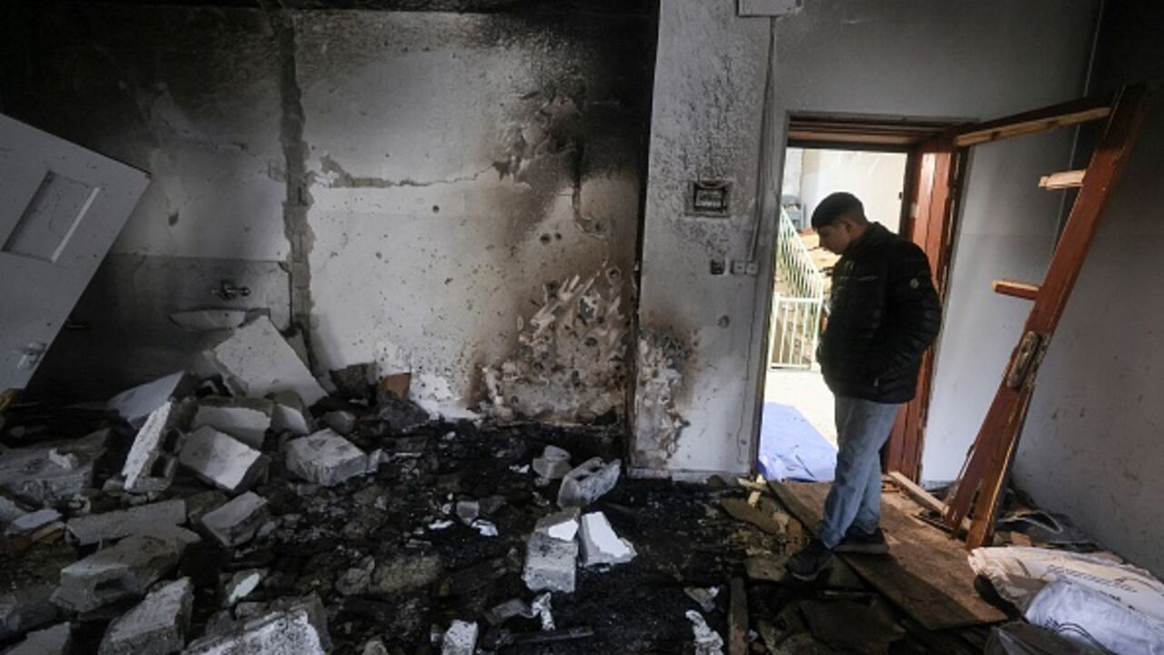 A man walks through an apartment the morning after it was destroyed during an Israeli military operation in the Israeli-occupied northern West Bank city of Nablus, on November 25, 2025. (JAAFAR ASHTIYEH / AFP via Getty Images)