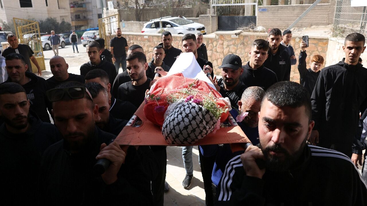Mourners carry the body of 16-year-old Palestinian Sami Mashayekh during his funeral