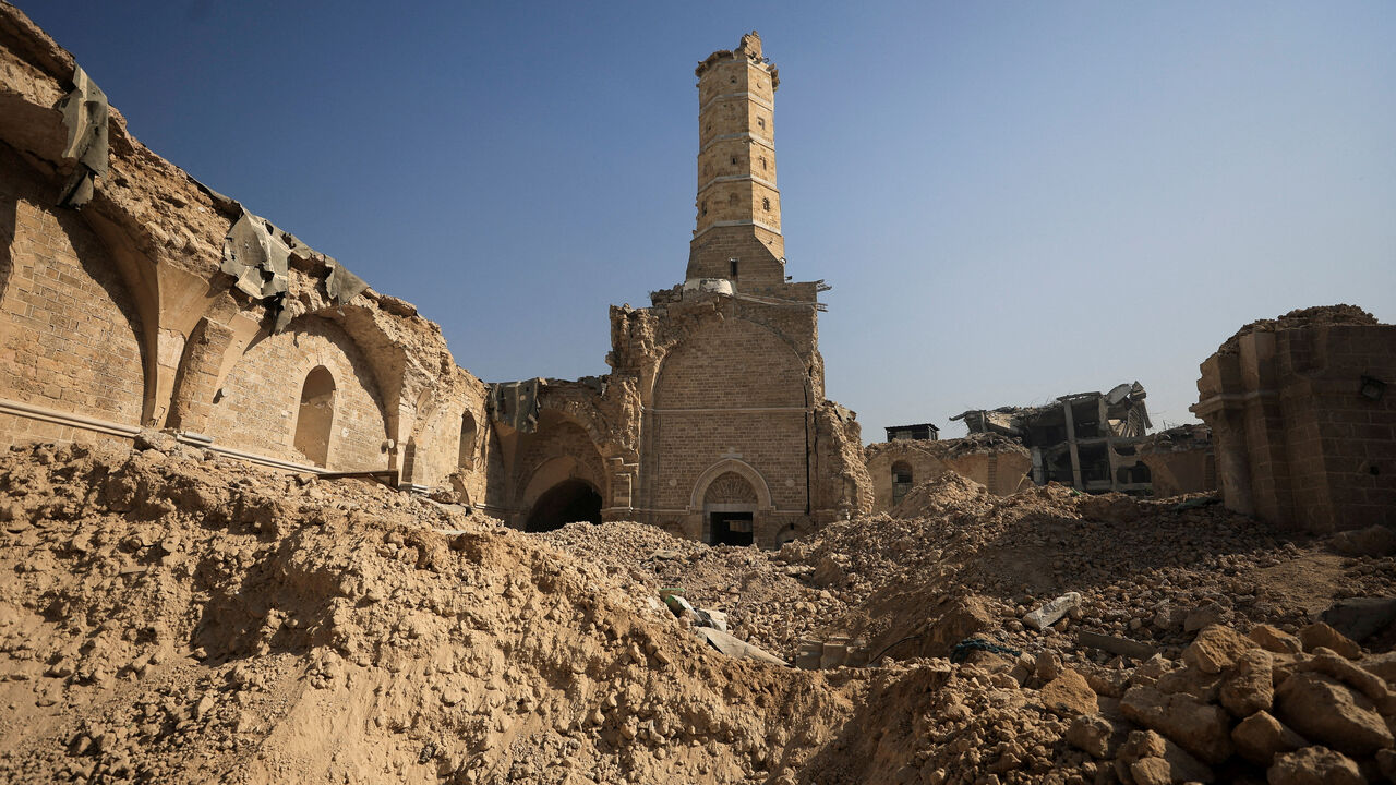 A view of Omari Mosque, which was damaged by Israeli shelling during the war, where Palestinians perform Friday prayers, in Gaza City, November 21, 2025. REUTERS/Dawoud Abu Alkas