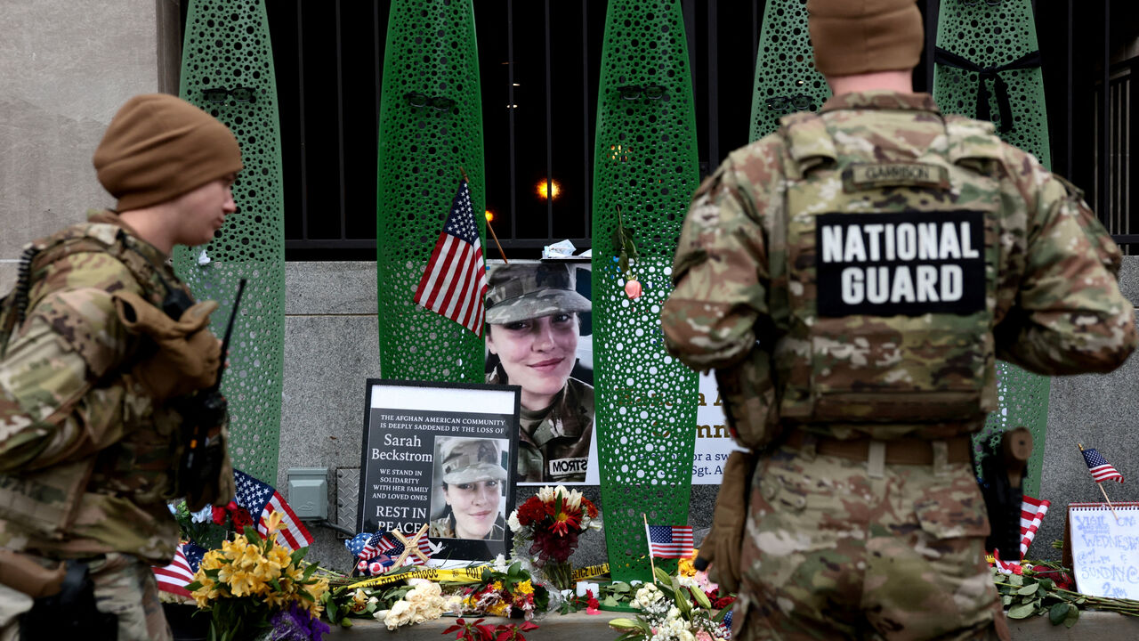 FILE PHOTO: National Guard soldiers from Alabama look at a makeshift memorial honouring West Virginia National Guard soldier Sarah Beckstrom, who, with her wounded fellow soldier Andrew Wolfe, was shot outside a subway station near the White House in Washington, D.C., U.S., December 2, 2025. REUTERS/Evelyn Hockstein/File Photo