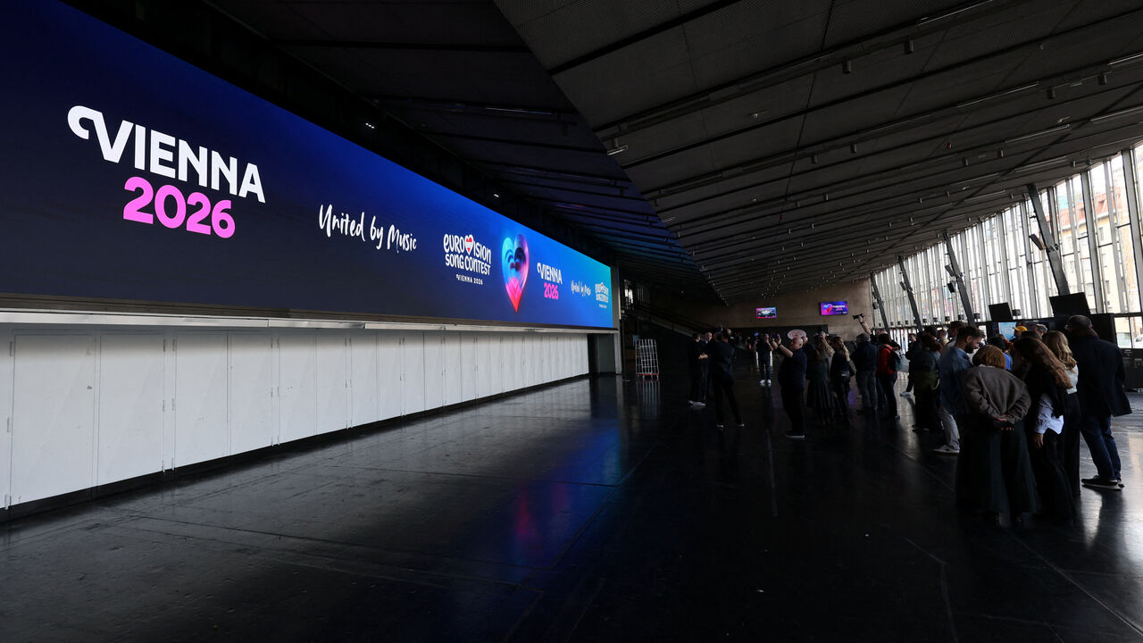 Journalists stand in front of a screen in Wiener Stadthalle, the venue of next year's Eurovision in Vienna, Austria, November 18, 2025. REUTERS/Leonhard Foeger