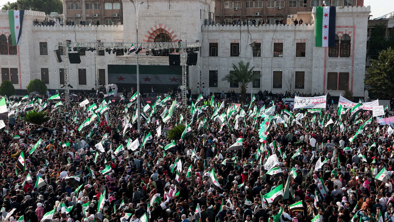 Residents of Hama gather during a protest to mark the first anniversary of the fall of Bashar al-Assad's regime, in Hama, Syria December 5, 2025. REUTERS/Mahmoud Hassano