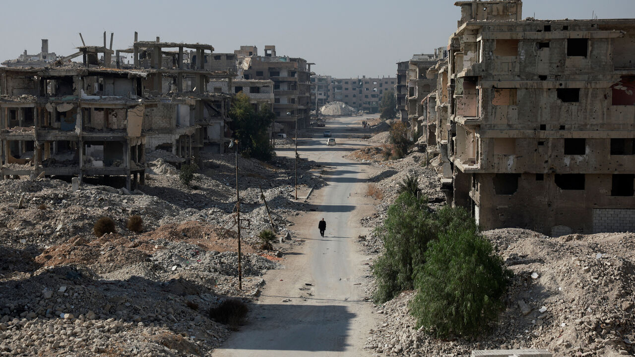 FILE PHOTO: A person walks on a street at al-Yarmouk Palestinian refugee camp, after Syria's Bashar al-Assad was ousted, in Damascus, Syria, December 16, 2024. REUTERS/Ammar Awad/File Photo