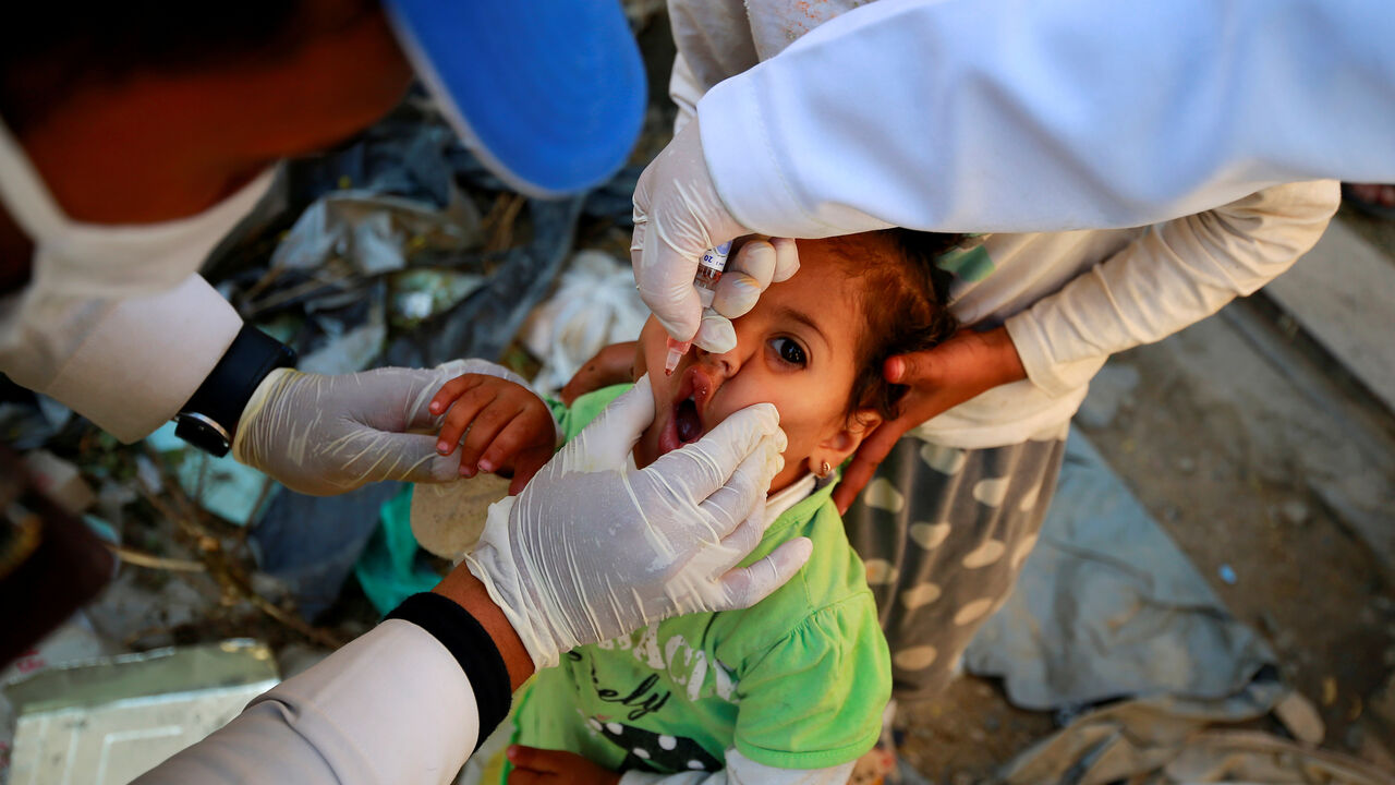 A girl receives a polio vaccine during a three-day immunization campaign in Sanaa, Yemen November 29, 2020. REUTERS/Nusaibah Almuaalemi