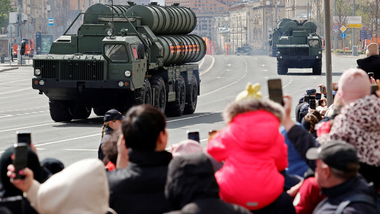 Spectators watch Russia's S-400 air defence system units driving along a road after a military parade on Victory Day, which marks the 79th anniversary of the victory over Nazi Germany in World War Two, in Moscow, Russia, May 9, 2024. REUTERS/Yulia Morozova