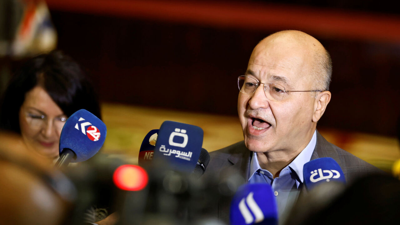 FILE PHOTO: Iraq's President Barham Salih speaks to members of the media as he casts his vote at a polling station in Baghdad, as Iraqis go to the polls to vote in the parliamentary election, in Iraq, October 10, 2021. REUTERS/Thaier al-Sudani/ File Photo