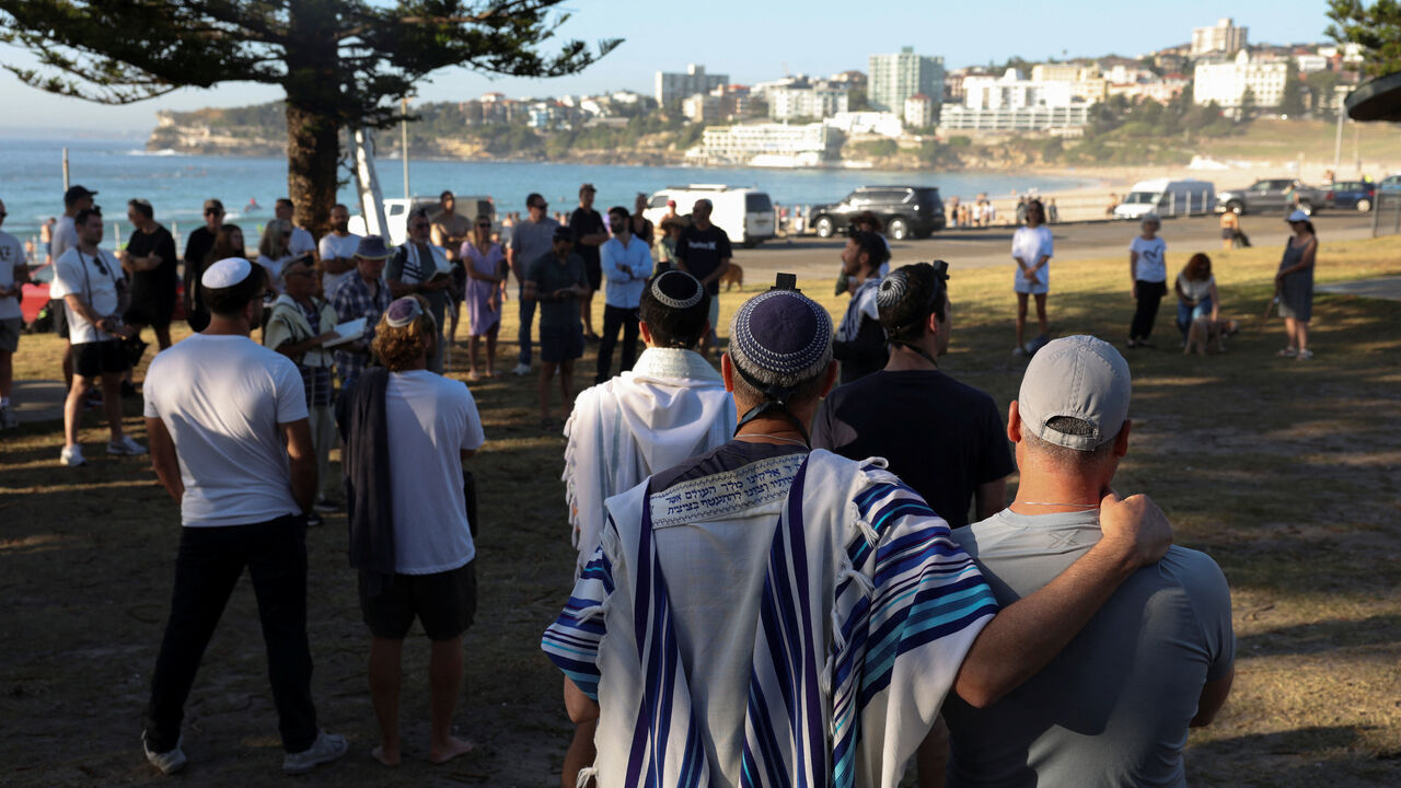 Members of the Jewish community gather for Shacharit, morning prayers, as the crime scene was reopened following the mass shooting at Bondi Beach on Sunday, in Sydney, Australia, December 19, 2025. REUTERS/Hollie Adams