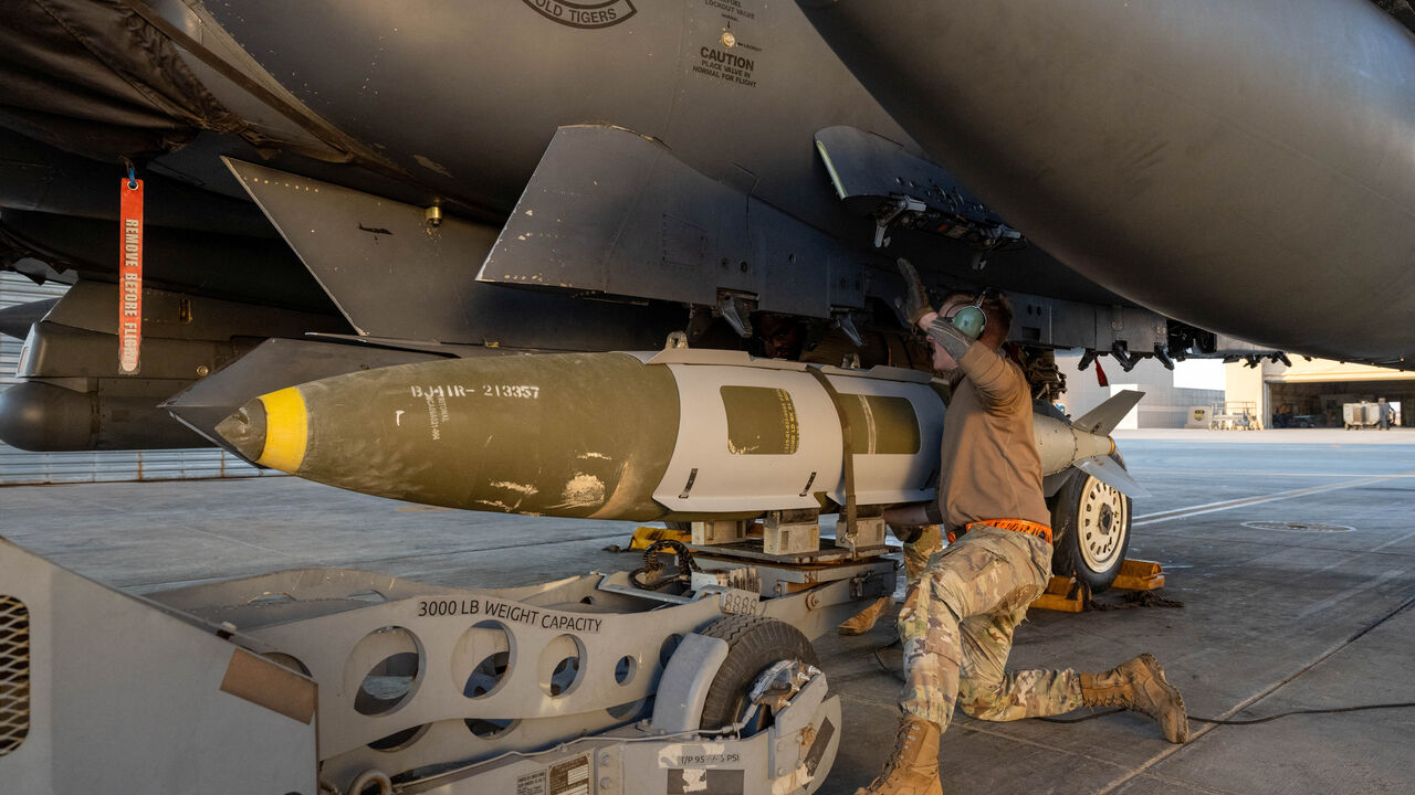 A U.S. Airman attaches a GBU-31 munitions system to an F-15E Strike Eagle in the U.S. Central Command area of responsibility, December 19, 2025, in support of Operation Hawkeye Strike as the U.S. military launched large-scale strikes against dozens of Islamic State targets in Syria in retaliation for an attack on U.S. personnel, U.S. officials said.  U.S. Air Force Photo/Handout via REUTERS