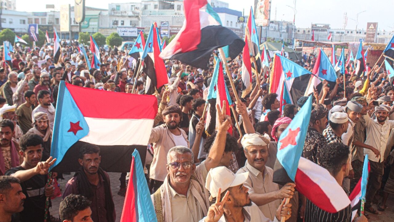 Supporters of the UAE-backed Southern Transitional Council wave flags of South Yemen, which unified with the north in 1990, in the coastal port city of Aden