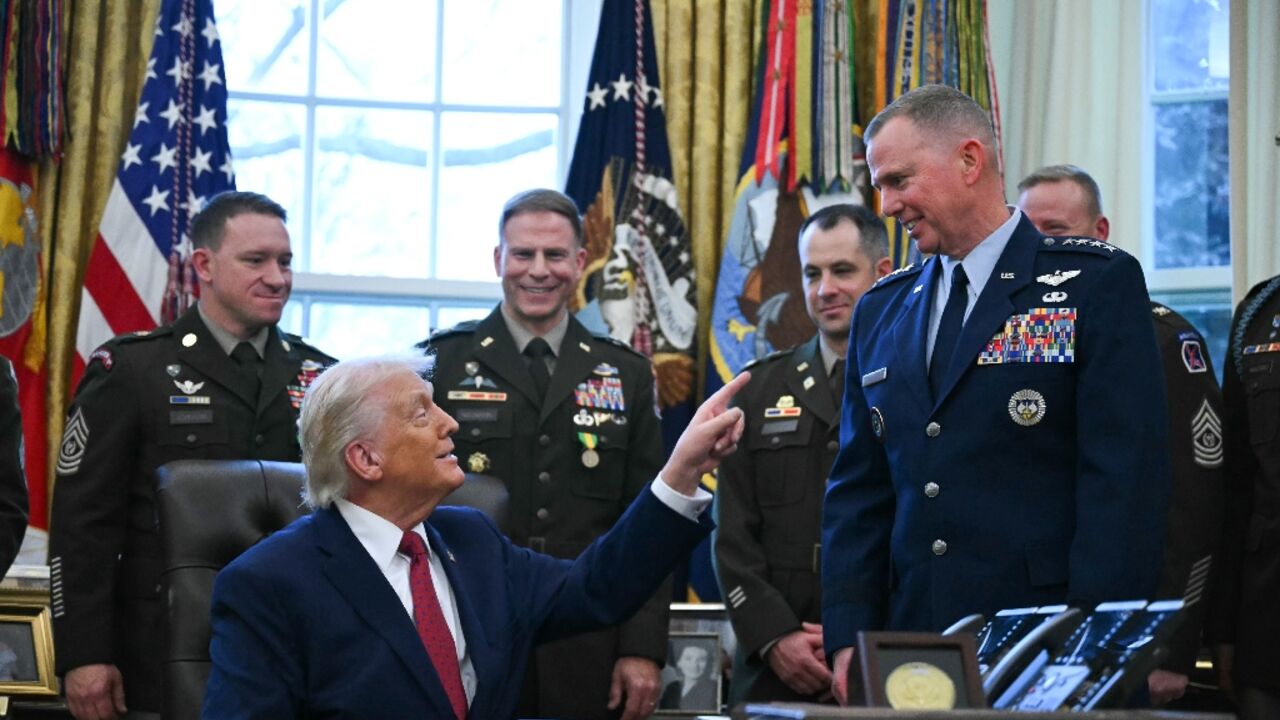 US President Donald Trump speaks with military officers at the White House