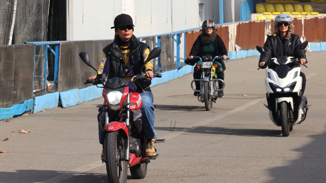 Instructor Maryam Ghelich (L) gives women students a lesson in riding motorbikes at a training centre in northern Tehran