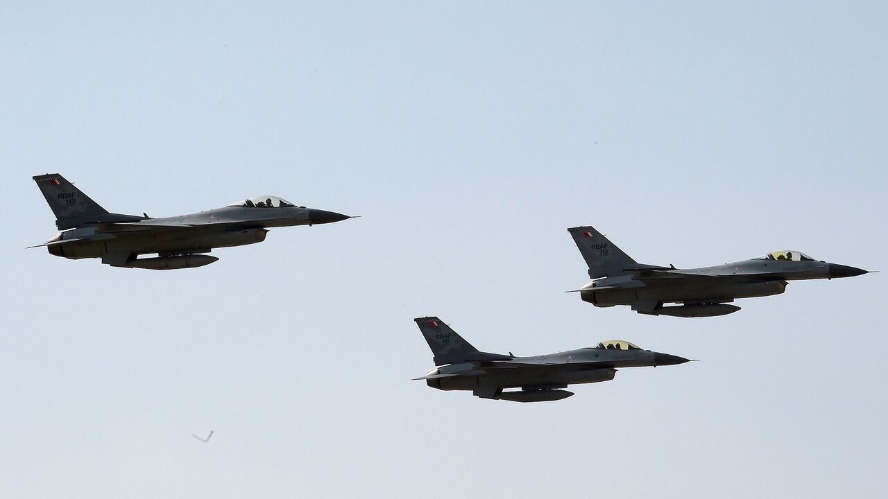 Royal Bahraini Air Force F-16s perform air maneuvers during the 2018 Bahrain International Airshow at the Sakhir Airbase on Nov. 14 2018. 