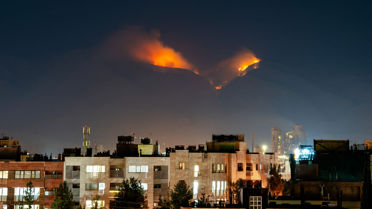 Smoke rises as fire burns, in an alleged site of IRGC's missile launch targeted by Israel on the mountains of Shiraz, Iran on June 21, 2025. Israel attacked Iran in early hours of June 13, and the exchange of fire between the two countries continues ever since. (Photo by Hiroon / Middle East Images via AFP) (Photo by HIROON/Middle East Images/AFP via Getty Images)