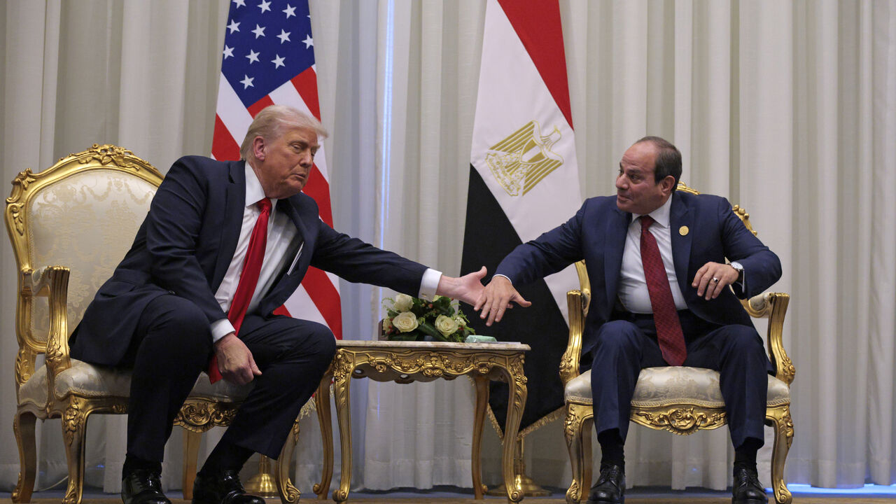 SHARM EL-SHEIKH, EGYPT - OCTOBER 13: U.S. President Donald Trump and President of Egypt Abdel Fattah El-Sisi clasp hands as they speak to the press before their meeting on October 13, 2025 in Sharm El-Sheikh, Egypt. President Trump is in Egypt to meet with European and Middle Eastern leaders in what’s being billed as an international peace summit, following the start of a US-brokered ceasefire deal to end the war in the Gaza Strip. (Photo by Chip Somodevilla/Getty Images)