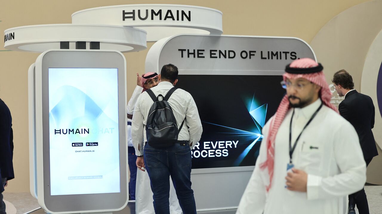 Guests stand at the booth of Saudi AI company Humain during the Future Investment Initiative conference in Riyadh on Oct. 29, 2025.