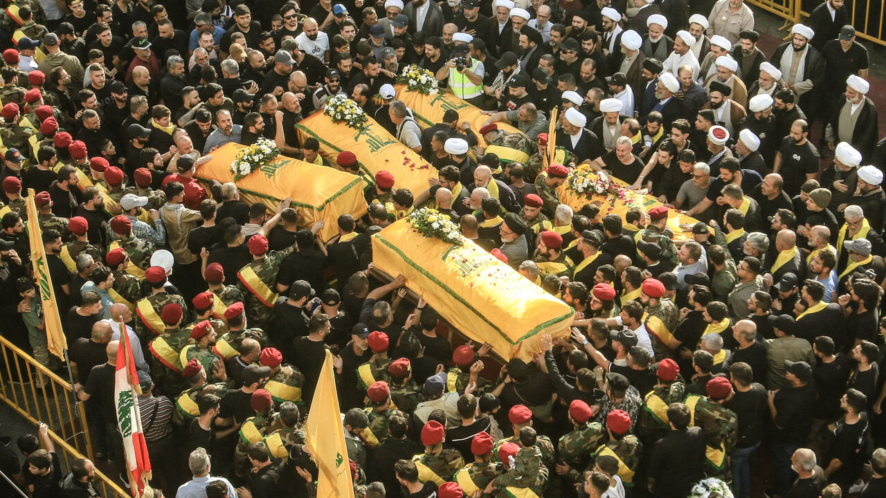 Supporters of Lebanon's Shiite militant group Hezbollah carry the coffins of militants killed in recent Israeli attacks during their funeral in the southern city of Nabatiyeh on November 2, 2025. Hundreds of people gathered in south Lebanon's Nabatiyeh on November 2, 2025 to mourn five Hezbollah members killed in recent Israeli attacks, an AFP correspondent said, as Israel warned of intensifying attacks against the Iran-backed group. On November 1, an Israeli strike killed four people in Kfar Rumman, Nabati