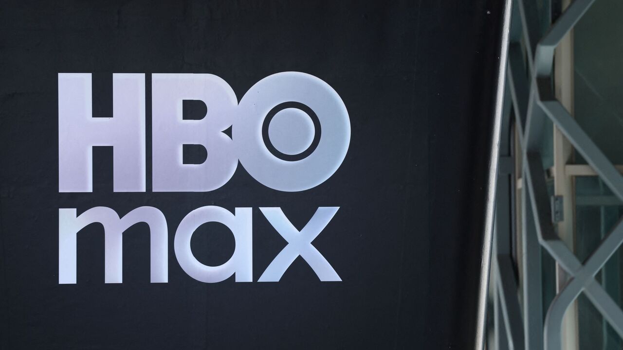 The HBO Max logo is seen outside the Warner Bros. Discovery offices in Culver City, California, on December 5, 2025. Streaming giant Netflix said December 5, 2025 it will buy film and television studio Warner Bros. Discovery for nearly $83 billion, the entertainment industry's biggest consolidation deal this decade. The acquisition gives Netflix access to a vast film catalog as well as the prestigious streaming service HBO Max. (Photo by Patrick T. Fallon / AFP via Getty Images)