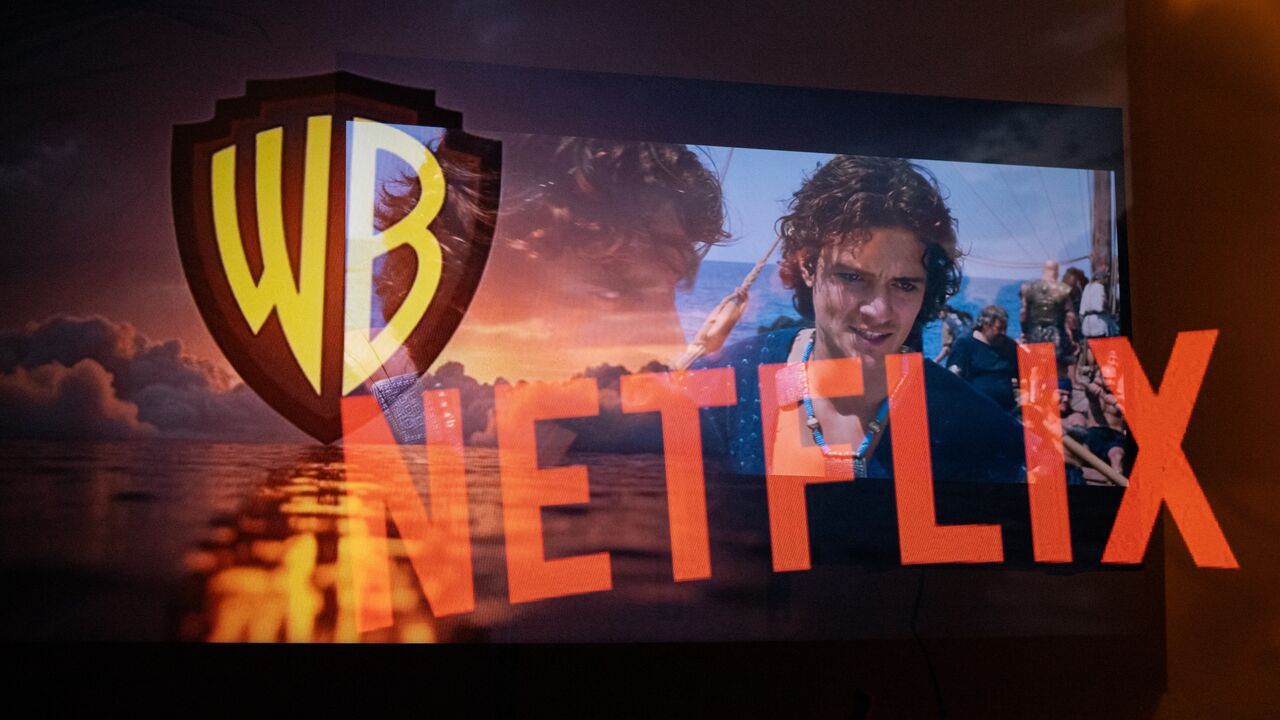 Multiple exposure photograph of the Netflix and Warner Bros logos in front of a television screen at Kerlouan in Brittany in France, on Dec. 5 2025.