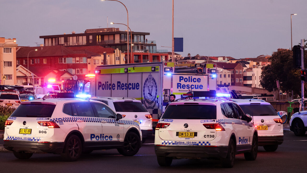 Police vehicles are seen on a road after a shooting incident at Bondi Beach in Sydney on Dec. 14, 2025. 