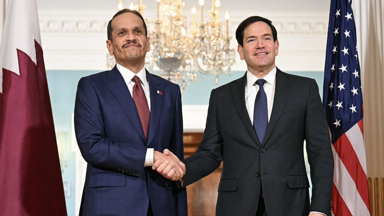 US Secretary of State Marco Rubio (R) shakes hands with Qatari Prime Minister and Foreign Minister Mohammed bin Abdulrahman al-Thani at the State Department in Washington, on Dec. 17, 2025. 