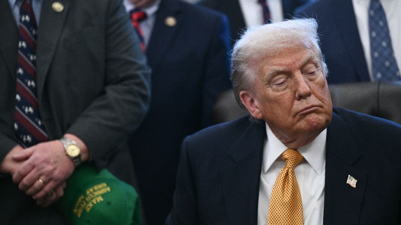 US President Donald Trump looks on before signing a bill on January 14, 2026 at the White House, where he discussed tensions with Iran 
