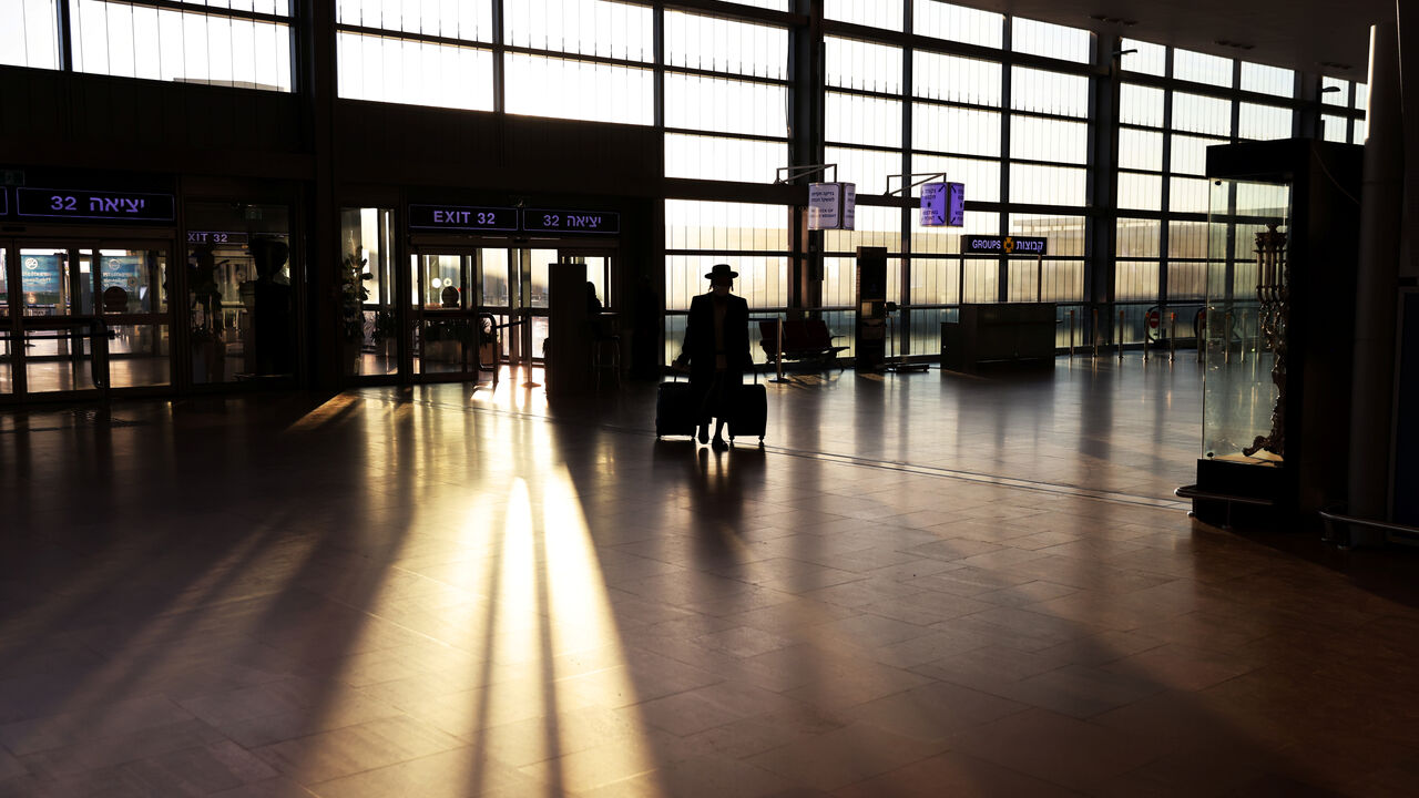 A passenger arrives to a terminal at Ben Gurion International Airport in Lod near Tel Aviv, Israel, January 25, 2021. REUTERS/Ronen Zvulun