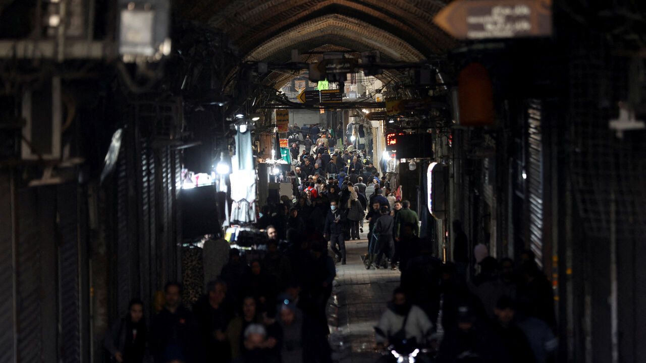 FILE PHOTO: People walk past closed shops, following protests over a plunge in the currency's value, in the Tehran Grand Bazaar in Tehran, Iran, December 30, 2025. Majid Asgaripour/WANA (West Asia News Agency) via REUTERS/File photo