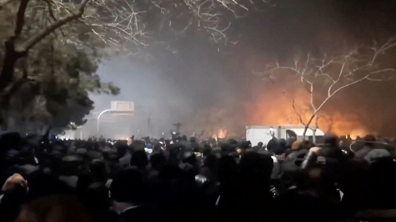 Smoke rises as protesters gather amid evolving anti-government unrest at Vakilabad highway in Mashhad, Razavi Khorasan province, Iran, released on January 10, 2026, in this screen grab obtained from a social media video. SOCIAL MEDIA/via REUTERS