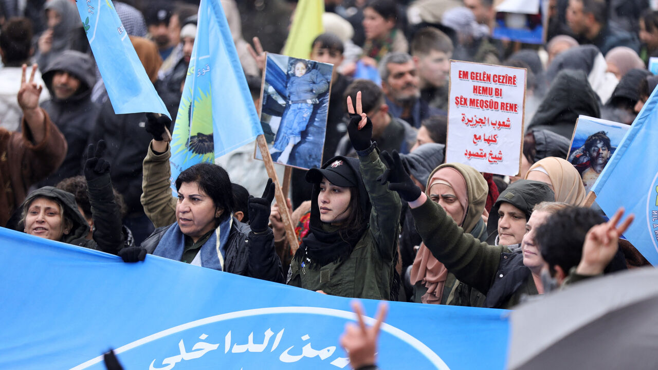 Syrian Kurds attend a protest in solidarity with the people in the neighborhood of Sheikh Maksoud and Ashrafiya, as The last Kurdish-led Syrian Democratic Forces (SDF) fighters left the Syrian city of Aleppo on Sunday, state-run Ekhbariya TV said, following a ceasefire deal that allowed evacuations after days of deadly clashes, in Qamishli, Syria January 13, 2026. REUTERS/Orhan Qereman