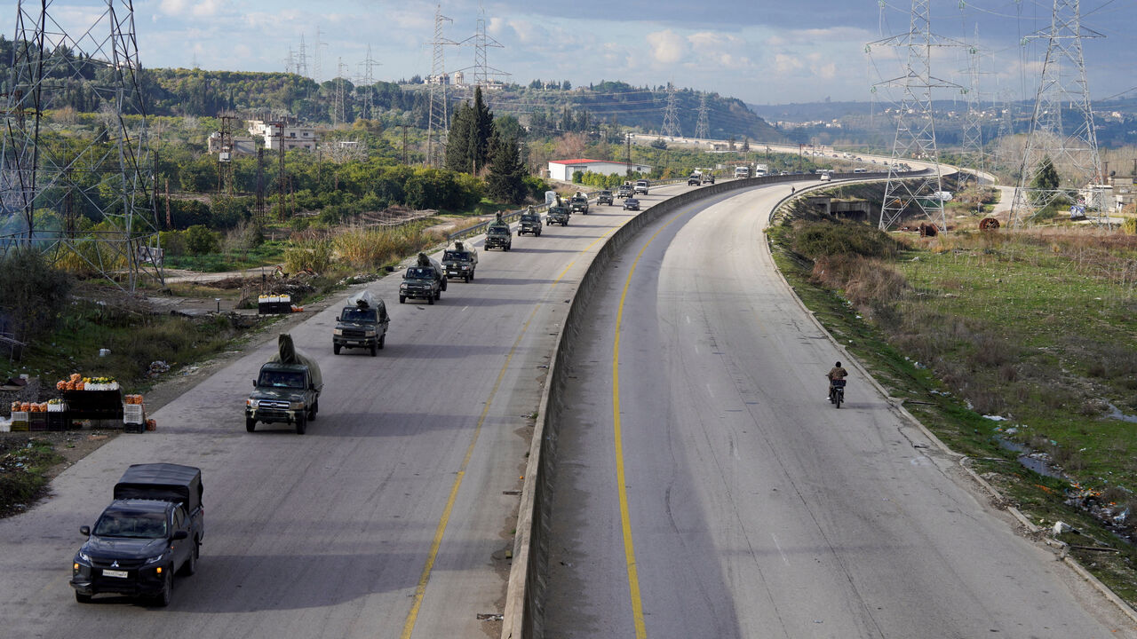 Military vehicles drive along a road, as Syrian state agency, SANA, reported on Wednesday that the Syrian army sent reinforcements from Latakia to "Deir Hafer front", amid escalating tensions and threats from the Syrian government to launch an offensive against Kurdish-led Syrian Democratic Forces (SDF), in Latakia, Syria, January 14, 2026. REUTERS/Karam al-Masri