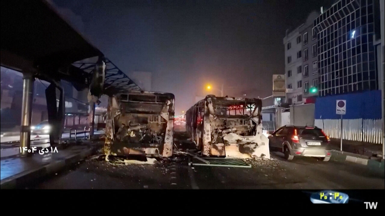 Burnt vehicles lie on the road following unrest sparked by dire economic conditions, in a place given as Tehran, Iran, January 10, 2026, in this screengrab from Iran's state media broadcast footage. IRIB via WANA(West Asia News Agency)