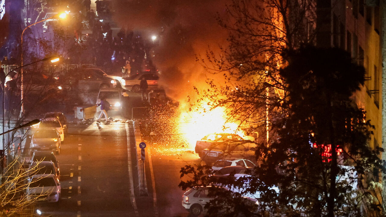 Cars burn in a street during a protest over the collapse of the currency's value, in Tehran, Iran, January 8, 2026. Stringer/WANA (West Asia News Agency) via REUTERS