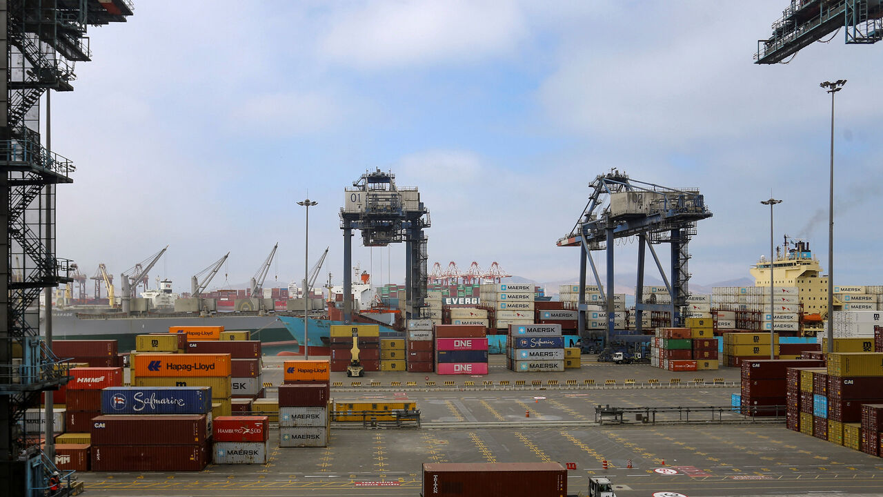 Workers handle containers at APM Terminals in the port of Callao, in Callao, Peru November 19, 2025. REUTERS/Gerardo Marin