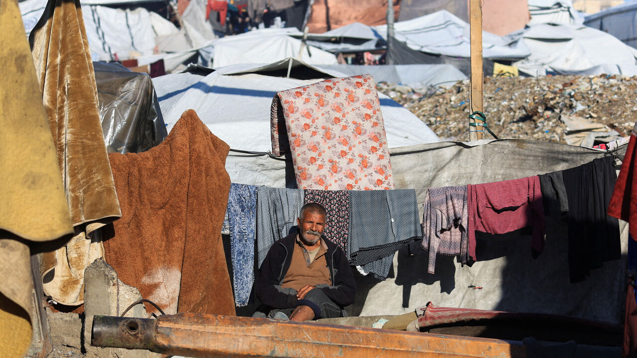 A displaced Palestinian man sits at a tent camp, after the United States said on Wednesday it is launching the second phase of its plan to end the Gaza war, in Gaza City, January 15, 2026. REUTERS/Dawoud Abu Alkas