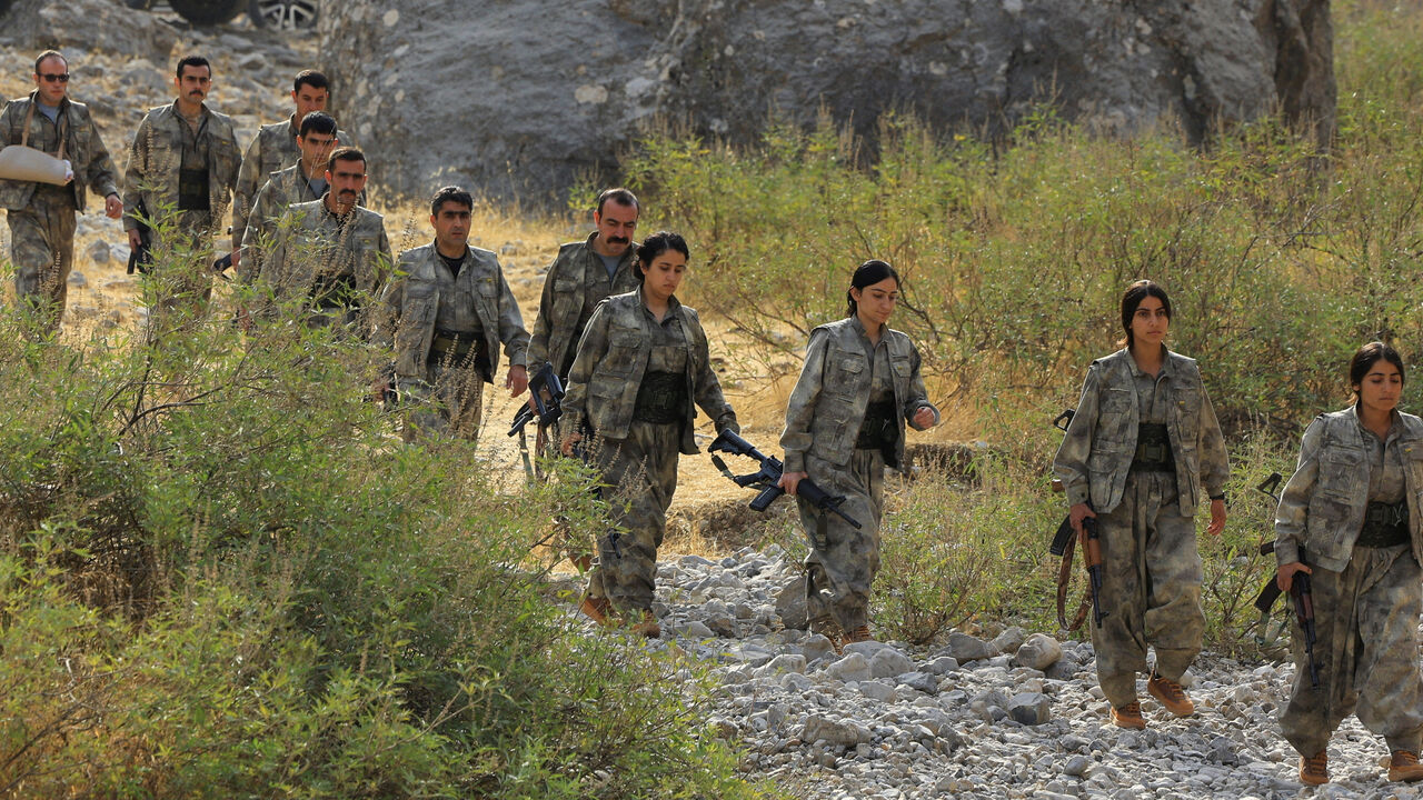 Fighters with the Kurdistan Workers' Party (PKK) walk for a disarmament ceremony marking a significant step toward ending the decades-long conflict between Turkey and the outlawed group, in the Qandil mountains, Iraq October 26, 2025. REUTERS/Thaier Al-Sudani