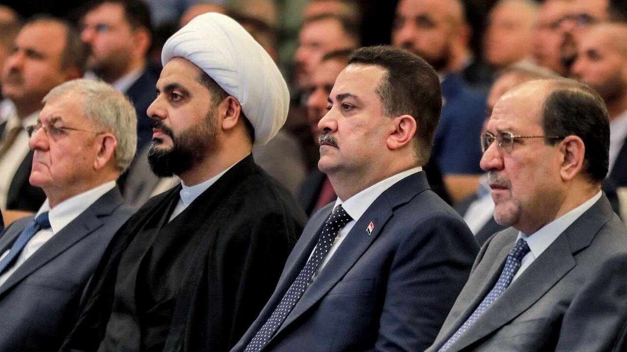 (L to R) Iraqi President Abdul Latif Rashid; Qais al-Khazali, head of the "Asaib Ahl al-Haq"; one of the member factions of the Hashd al-Shaabi (Popular Mobilization Forces) paramilitaries; Prime Minister Mohammed Shia al-Sudani; and former Prime Minister Nuri al-Maliki attend an event commemorating the 21st anniversary of the group's creation at a hotel in Baghdad on May 3, 2024.