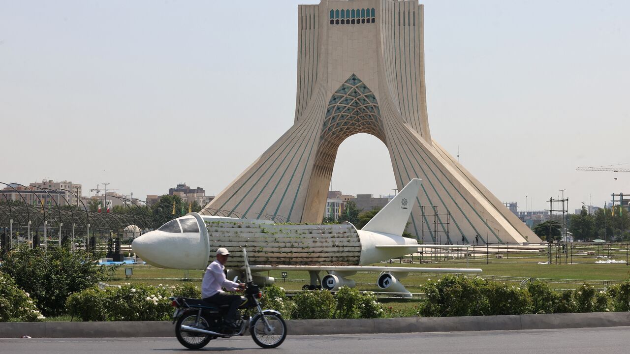 An Iranian rides his motorcycle near Azadi Square in Tehran, on June 14, 2025. 