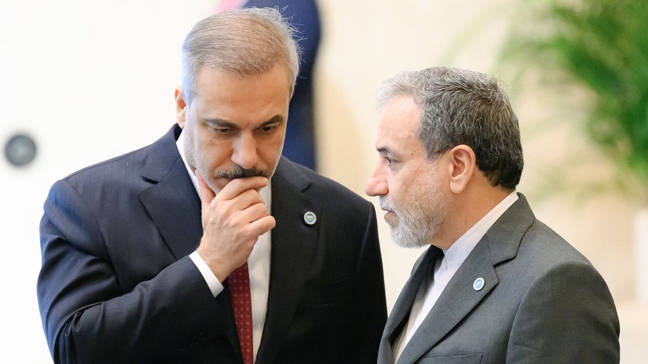Iranian Foreign Minister Abbas Araghchi (R) speaks with Turkish Foreign Minister Hakan Fidan (L) during the 51st session of the Council of Foreign Ministers of the Organization of Islamic Cooperation in Istanbul, on June 21, 2025.