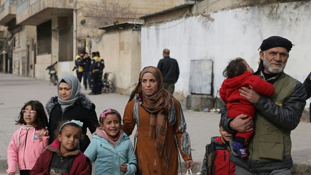 Residents flee from the predominantly Kurdish neighborhoods of Sheikh Maqsud and Ashrafiyeh in Aleppo, northern Syria on January 8, 2026, amid intense clashes between government forces and the Kurdish Syrian Democratic Forces. (Bakr ALkasem / AFP via Getty Images)